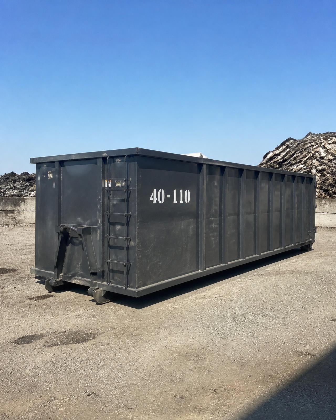Dark grey 40-yard roll-off container marked 40-110 in the Spartan Metals Houston yard